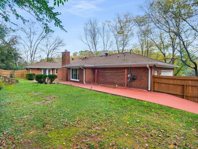 rear view of house featuring a patio and a yard