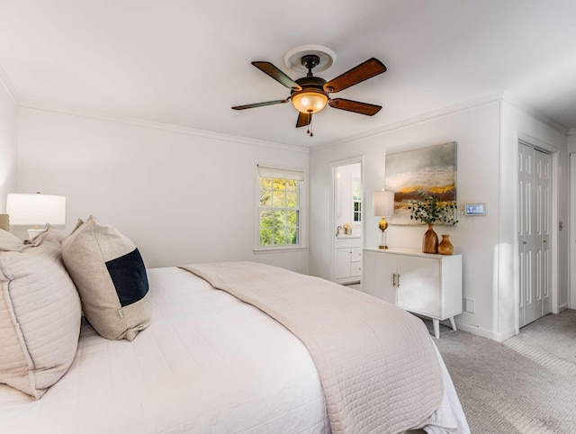 carpeted bedroom featuring ceiling fan, connected bathroom, and crown molding