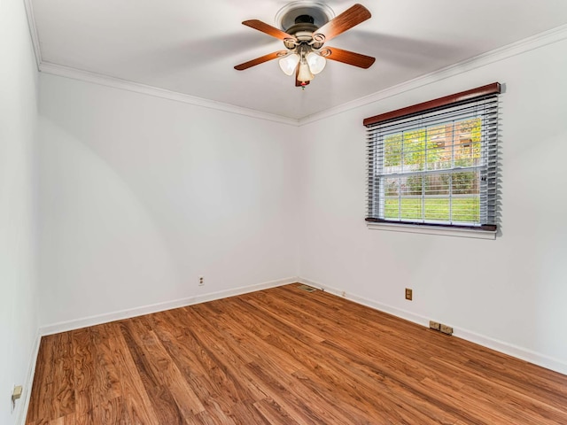 unfurnished room featuring hardwood / wood-style floors, ceiling fan, and crown molding