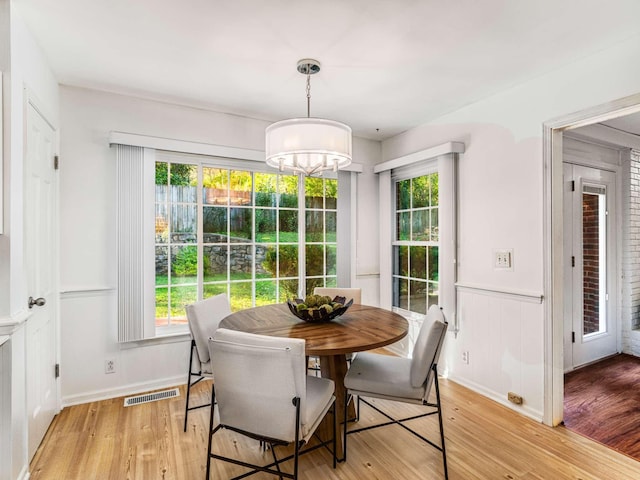 dining room featuring an inviting chandelier and light hardwood / wood-style flooring