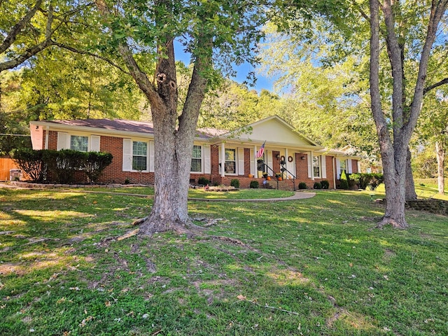 ranch-style house with covered porch and a front yard