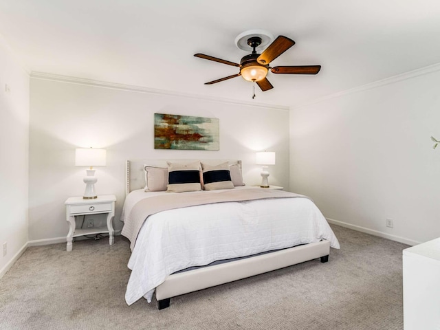 carpeted bedroom featuring ceiling fan and crown molding