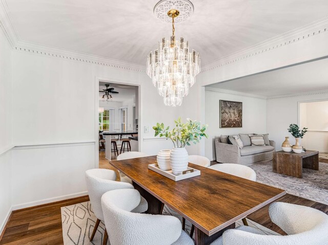 dining area featuring ceiling fan with notable chandelier and dark hardwood / wood-style flooring