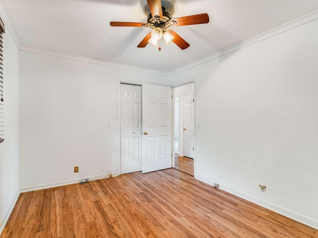 unfurnished bedroom with ceiling fan, crown molding, a closet, and light hardwood / wood-style flooring