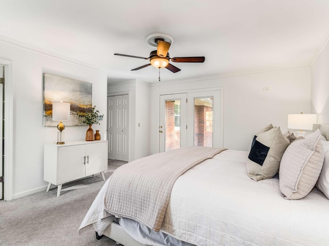 carpeted bedroom with ornamental molding and ceiling fan