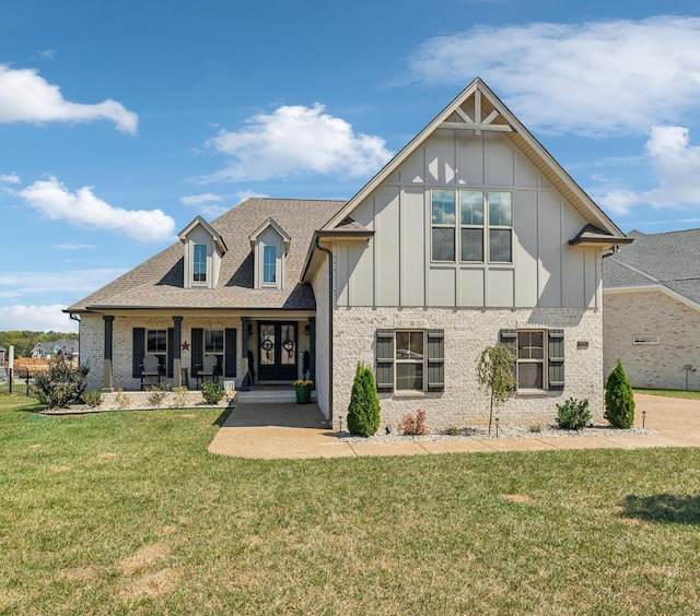 view of front facade with covered porch and a front yard