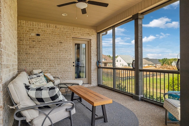 sunroom with ceiling fan and wooden ceiling