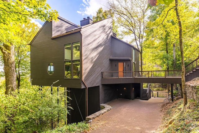 view of property exterior with a wooden deck