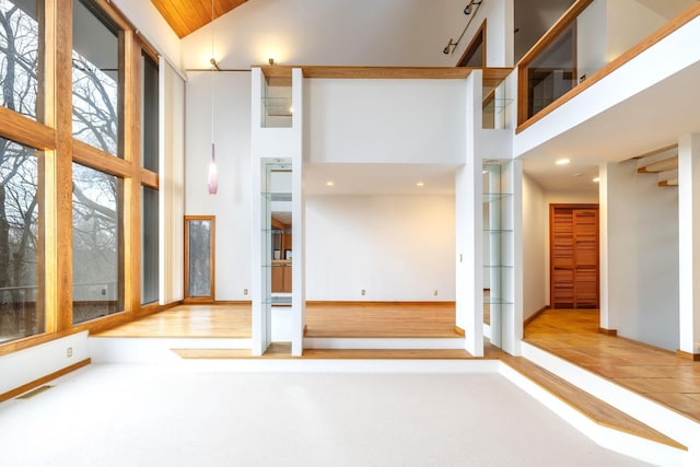 unfurnished room featuring a towering ceiling