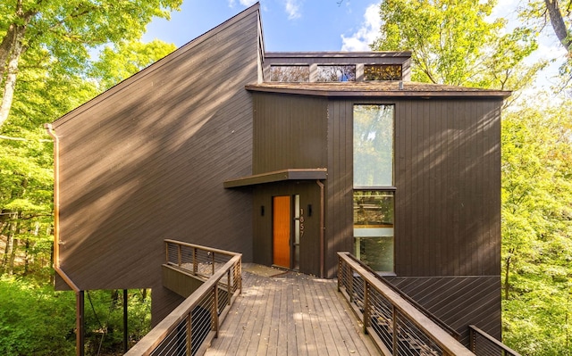 back of house with a wooden deck