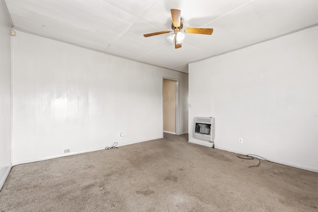 spare room featuring ceiling fan, heating unit, and carpet flooring