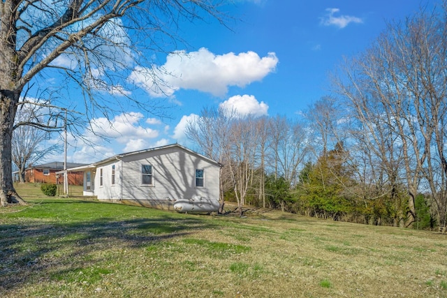 view of side of home featuring a lawn