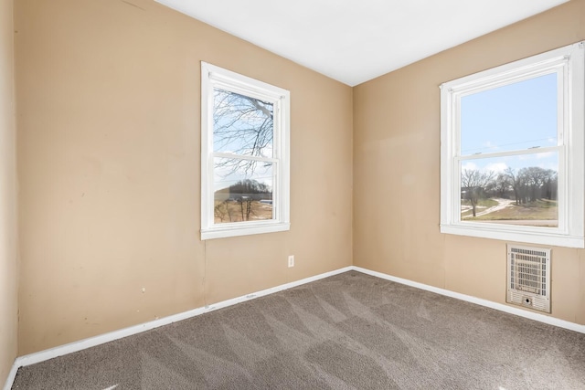 spare room with carpet and heating unit