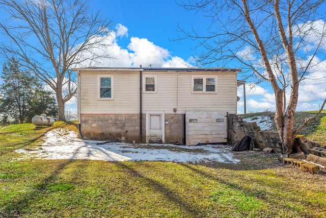 rear view of property featuring a yard