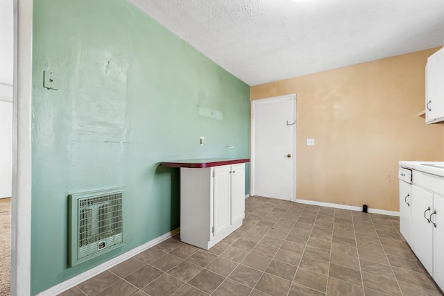 laundry area featuring heating unit