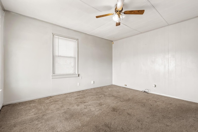 empty room with ceiling fan and carpet flooring