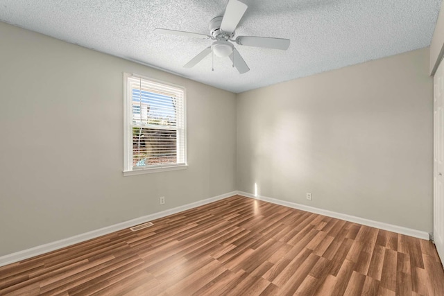 unfurnished room with a textured ceiling, ceiling fan, and hardwood / wood-style floors