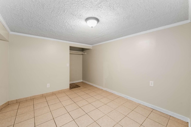 interior space featuring light tile patterned flooring, a textured ceiling, and ornamental molding