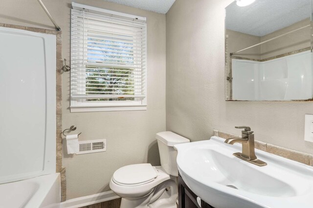 full bathroom featuring toilet, vanity, and washtub / shower combination