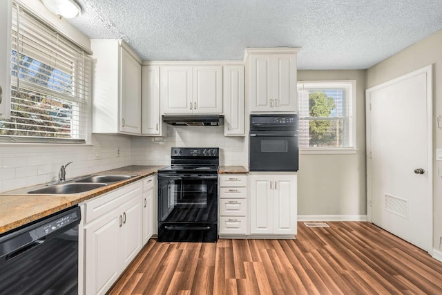 kitchen with black appliances, white cabinetry, dark hardwood / wood-style floors, and sink