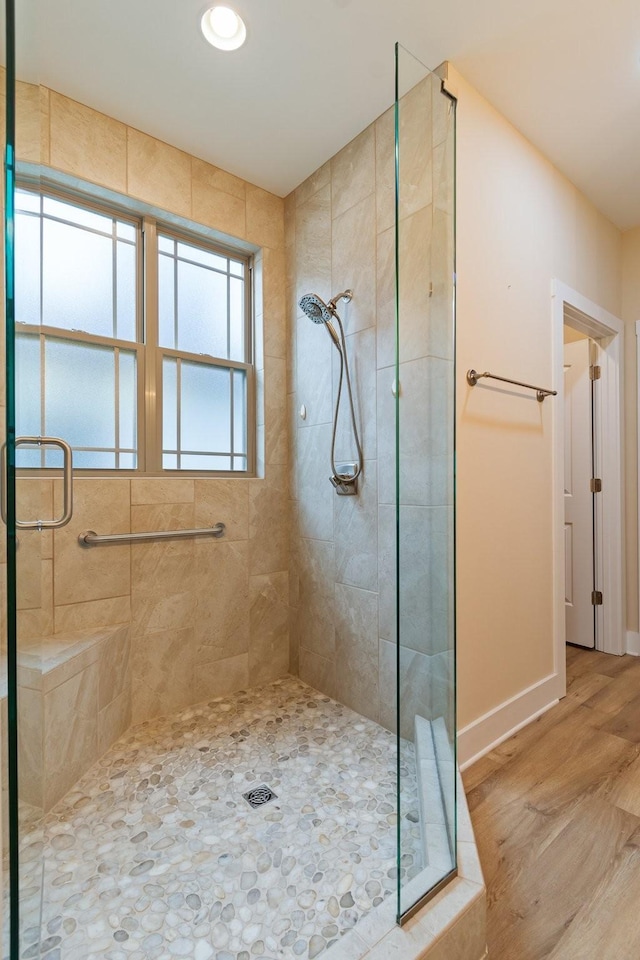 bathroom with walk in shower and wood-type flooring