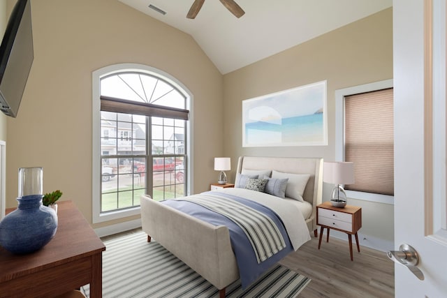 bedroom with lofted ceiling, ceiling fan, and light hardwood / wood-style flooring