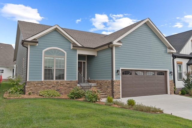 craftsman house featuring a garage and a front yard