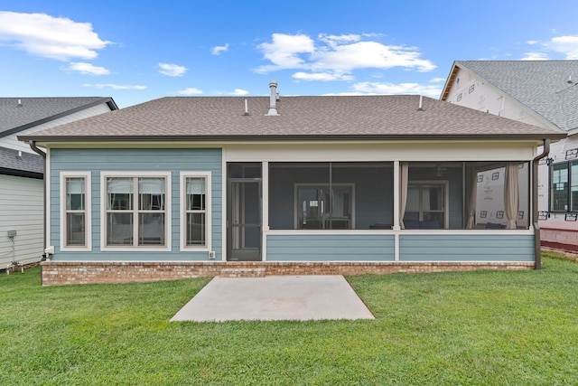 back of property with a sunroom and a lawn