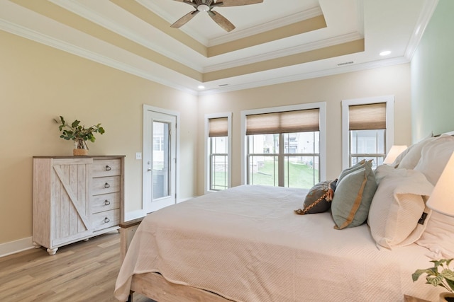 bedroom featuring access to outside, a raised ceiling, ceiling fan, light hardwood / wood-style flooring, and crown molding