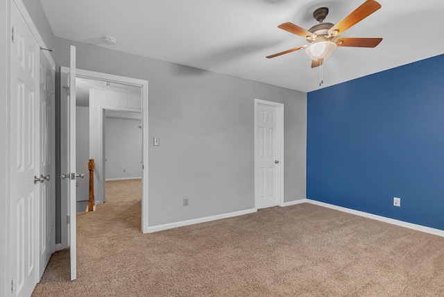 unfurnished bedroom with ceiling fan and light colored carpet