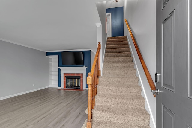 stairs featuring hardwood / wood-style flooring and ornamental molding