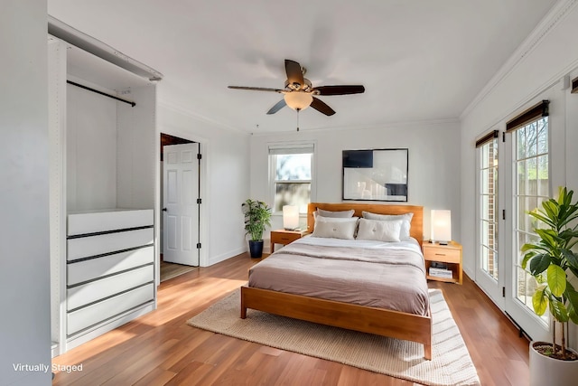 bedroom with ceiling fan, light hardwood / wood-style flooring, ornamental molding, and access to exterior