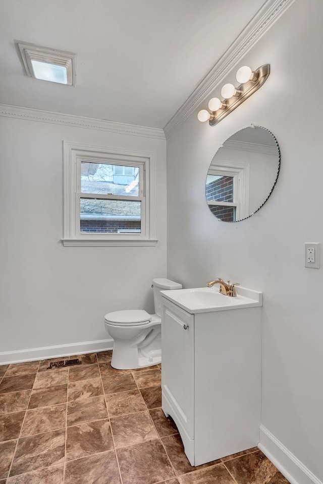 bathroom featuring toilet, ornamental molding, and vanity