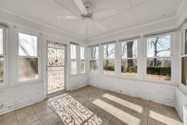 unfurnished sunroom with ceiling fan