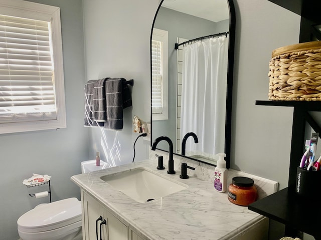 bathroom featuring toilet and vanity