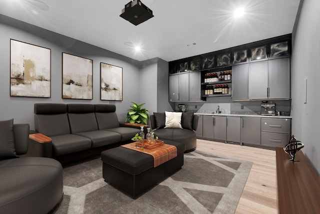 living room with light hardwood / wood-style flooring and sink