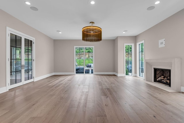 unfurnished living room with light hardwood / wood-style floors and plenty of natural light