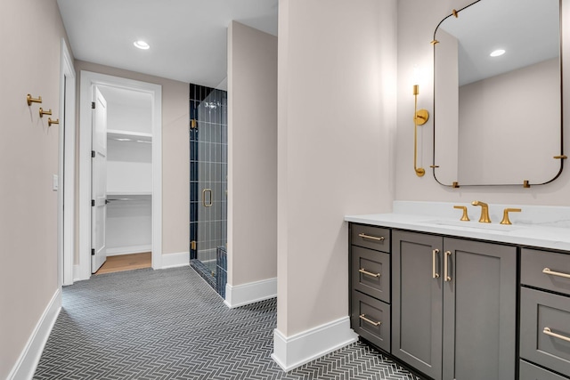 bathroom featuring vanity and a shower with shower door