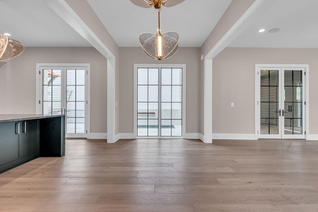 interior space with light hardwood / wood-style flooring and french doors