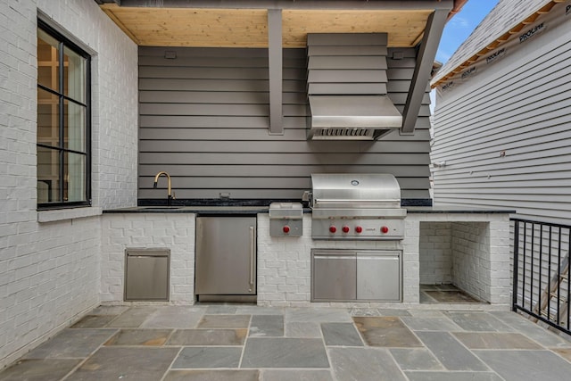 view of patio with sink, exterior kitchen, and grilling area