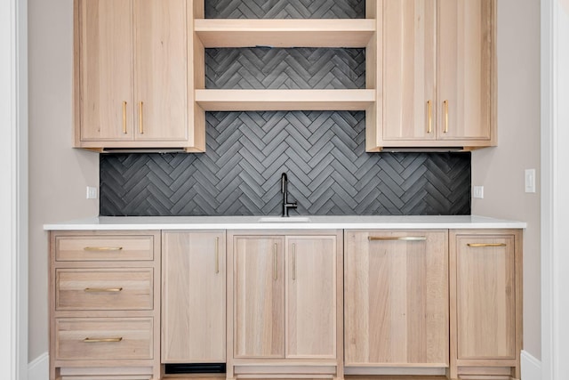 kitchen with sink, decorative backsplash, and light brown cabinets