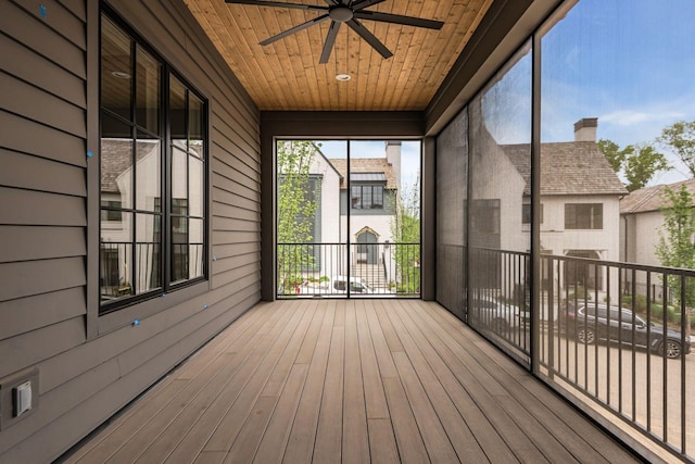 unfurnished sunroom featuring ceiling fan and wood ceiling