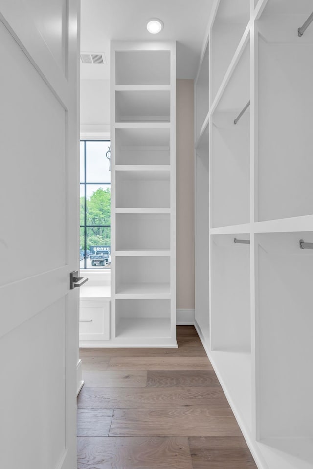 walk in closet featuring hardwood / wood-style flooring