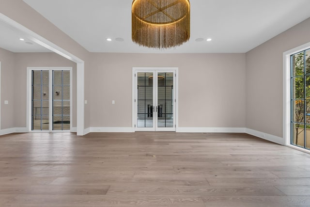 unfurnished room featuring light hardwood / wood-style flooring and french doors