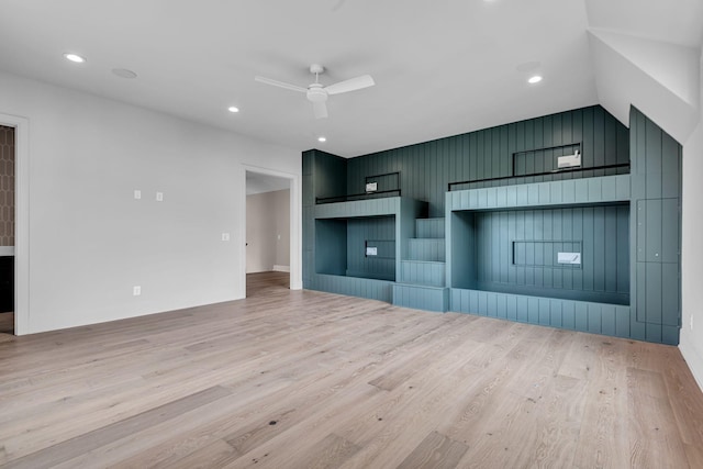 unfurnished living room featuring ceiling fan and light wood-type flooring