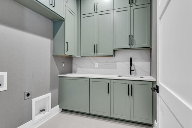 laundry area featuring sink, cabinets, hookup for a washing machine, and hookup for an electric dryer