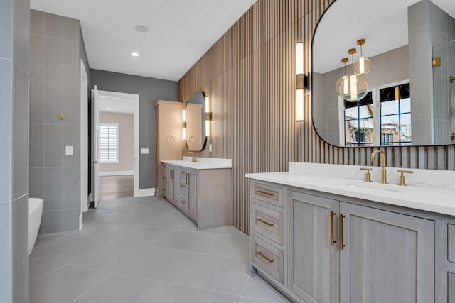 bathroom featuring tile patterned floors, vanity, and tile walls