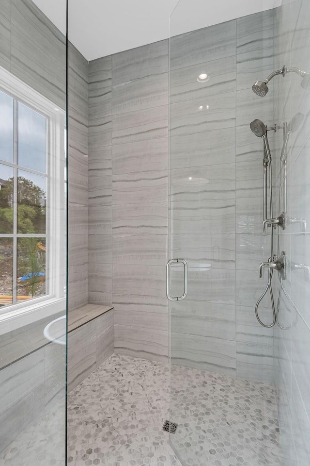 bathroom with a shower with shower door