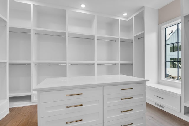 spacious closet with light hardwood / wood-style floors