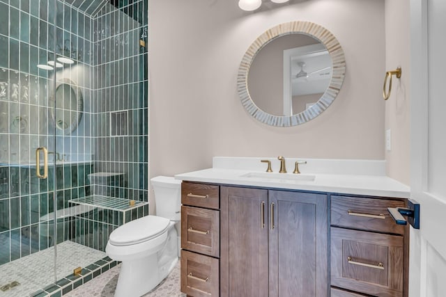 bathroom with tile patterned flooring, an enclosed shower, vanity, and toilet